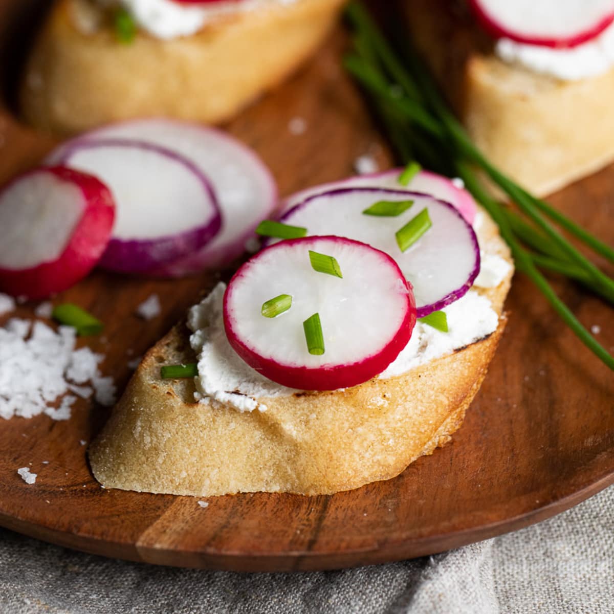 Slice of bread with cream and radishes