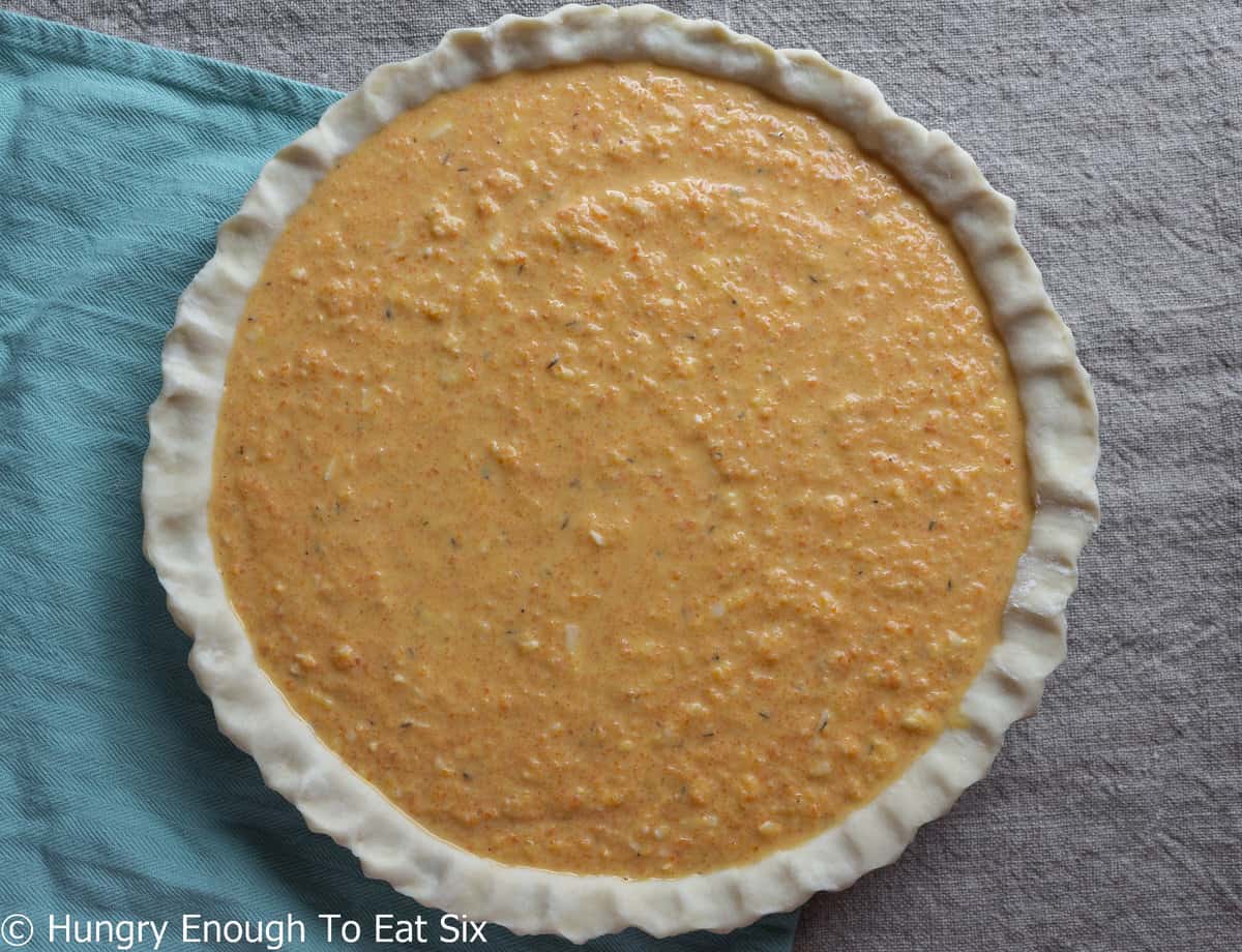 Orange cheese and carrot filling in pie shell.