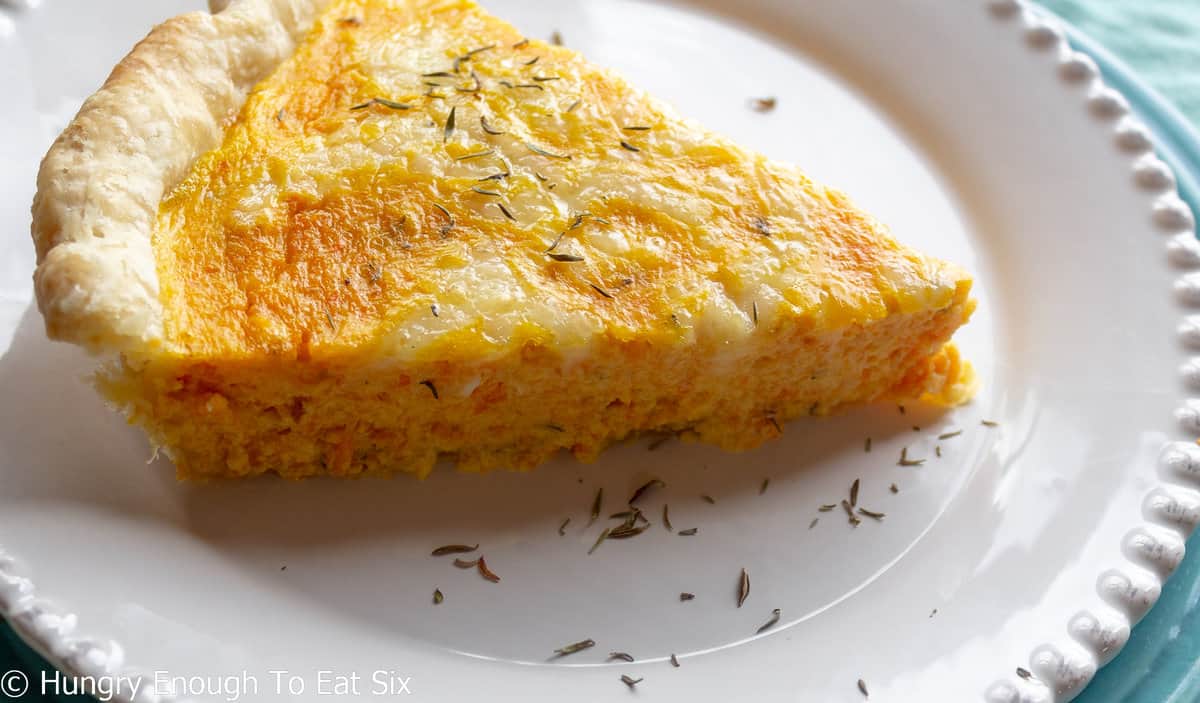 Carrot quiche with melted cheese and dried herbs.