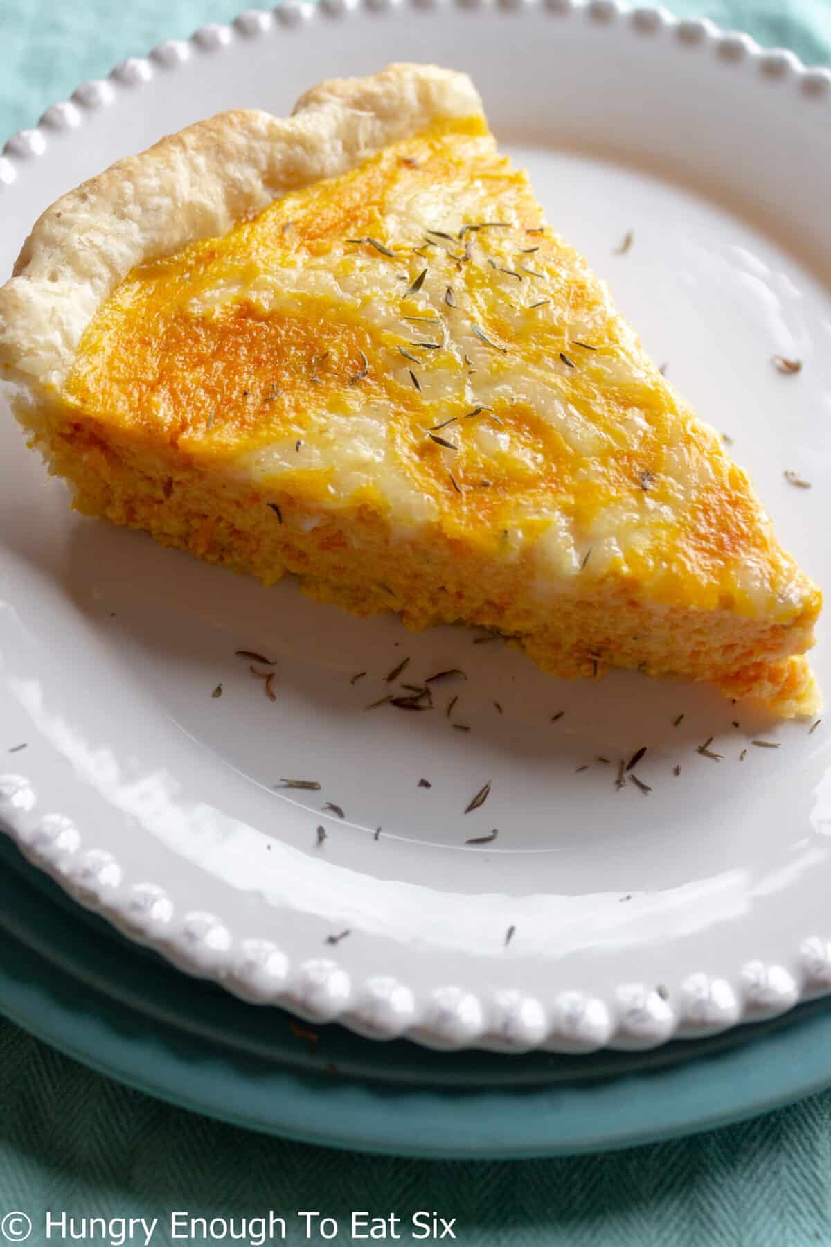 Orange-colored quiche slice made with carrots and cheese.