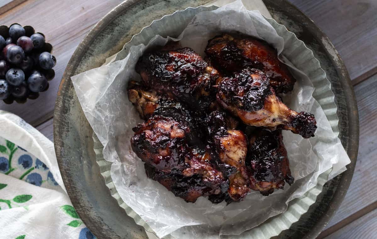 Chicken drumsticks with thick blueberry ketchup glaze.