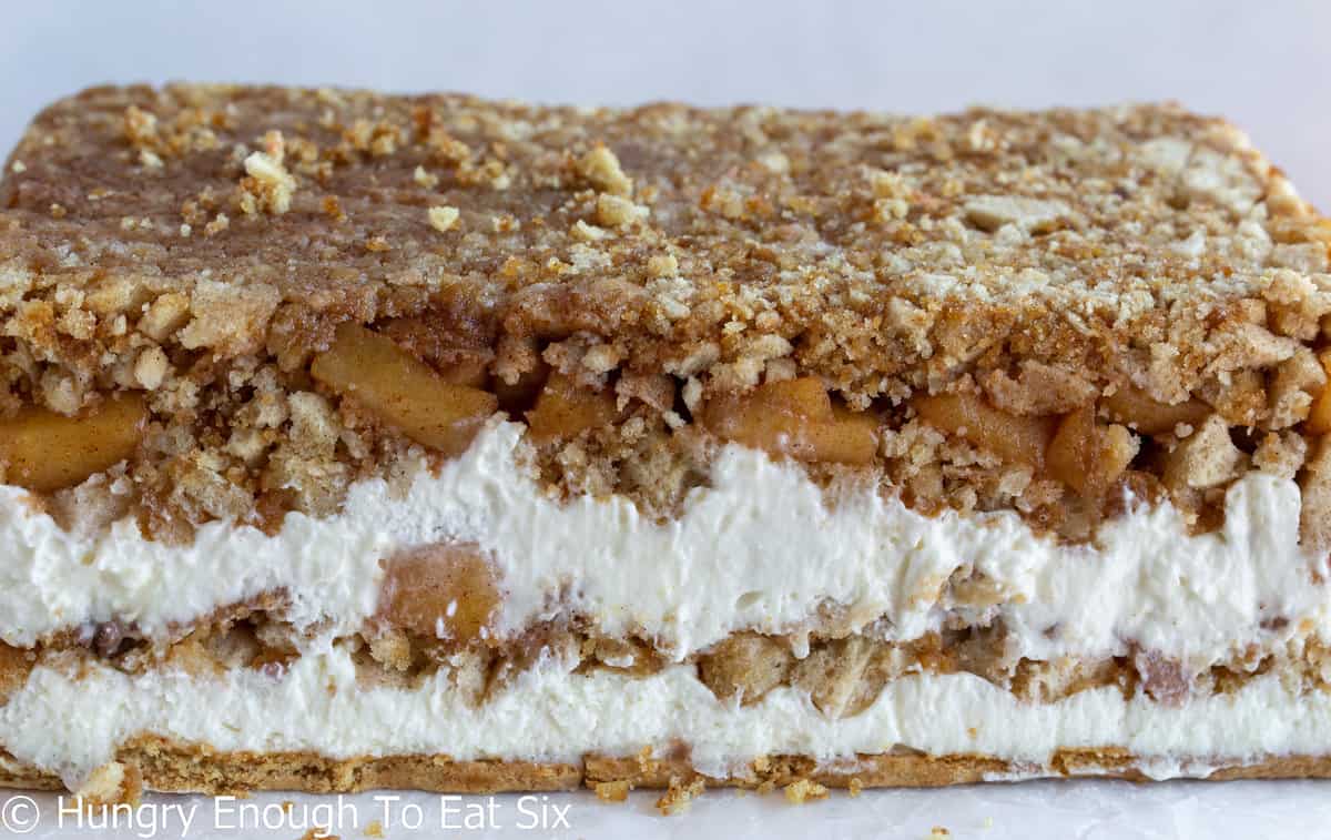 Closeup of apple, donut and cream layers inside an icebox cake.
