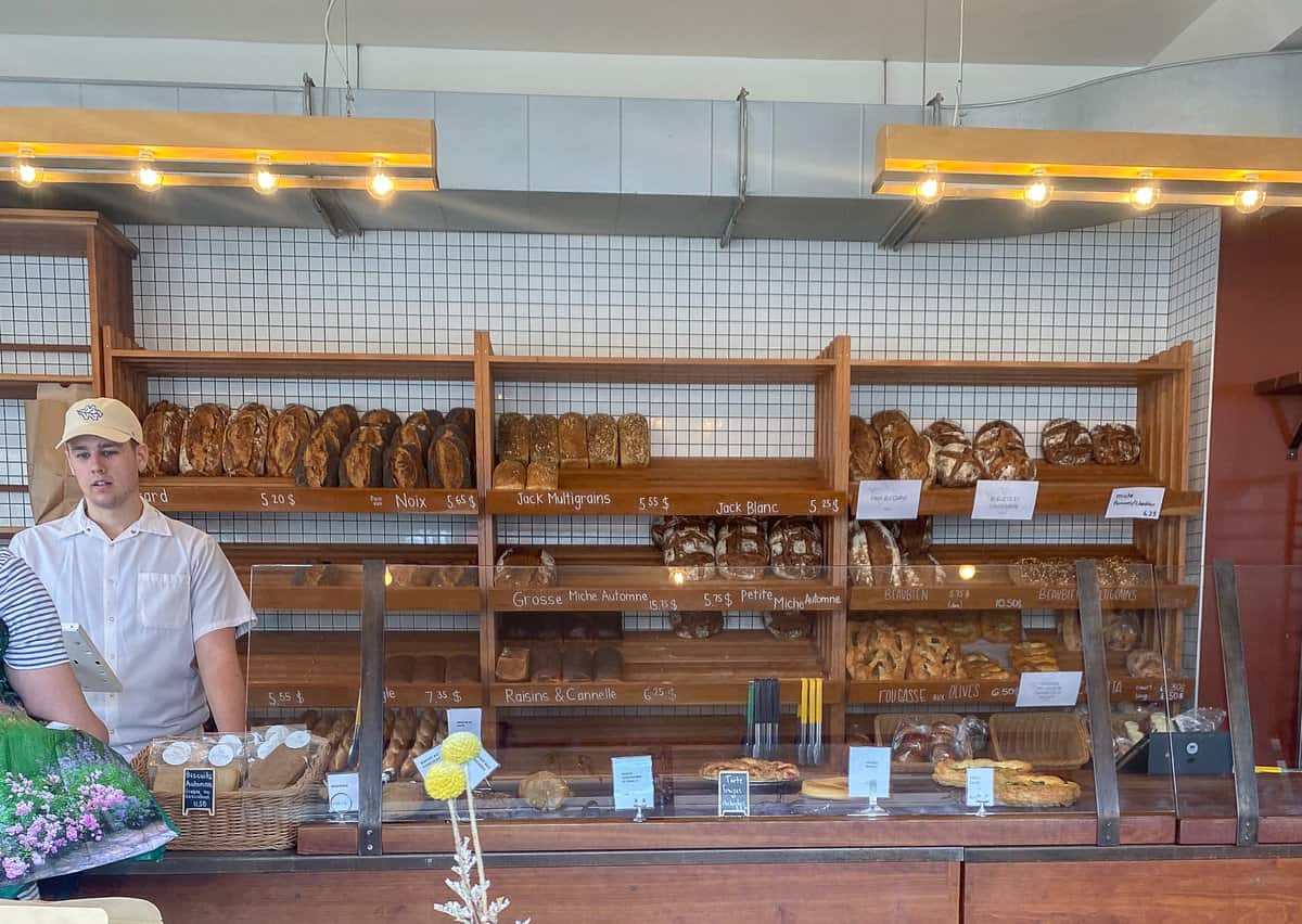 Bread shelves inside a bakery.