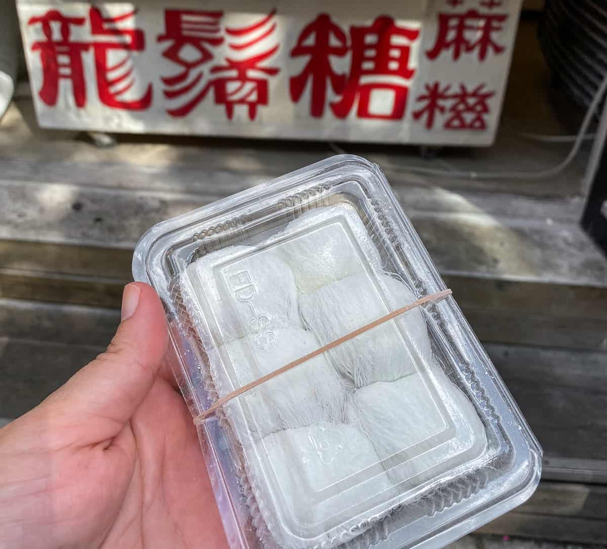 Plastic box with white, spun sugar candies inside.