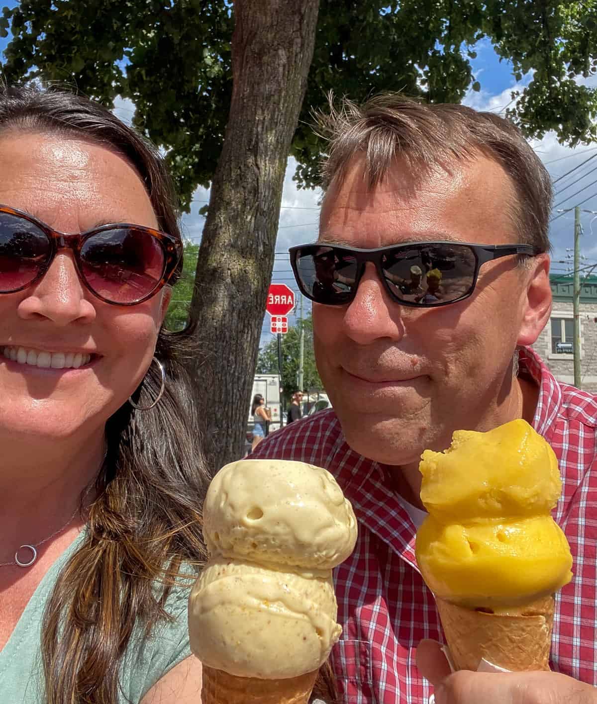 Woman and man wearing sunglasses and holding ice cream cones