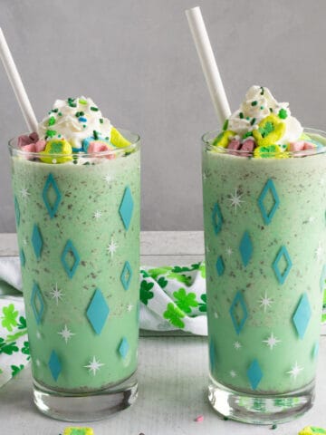 Cream and sprinkles-topped green milkshakes.