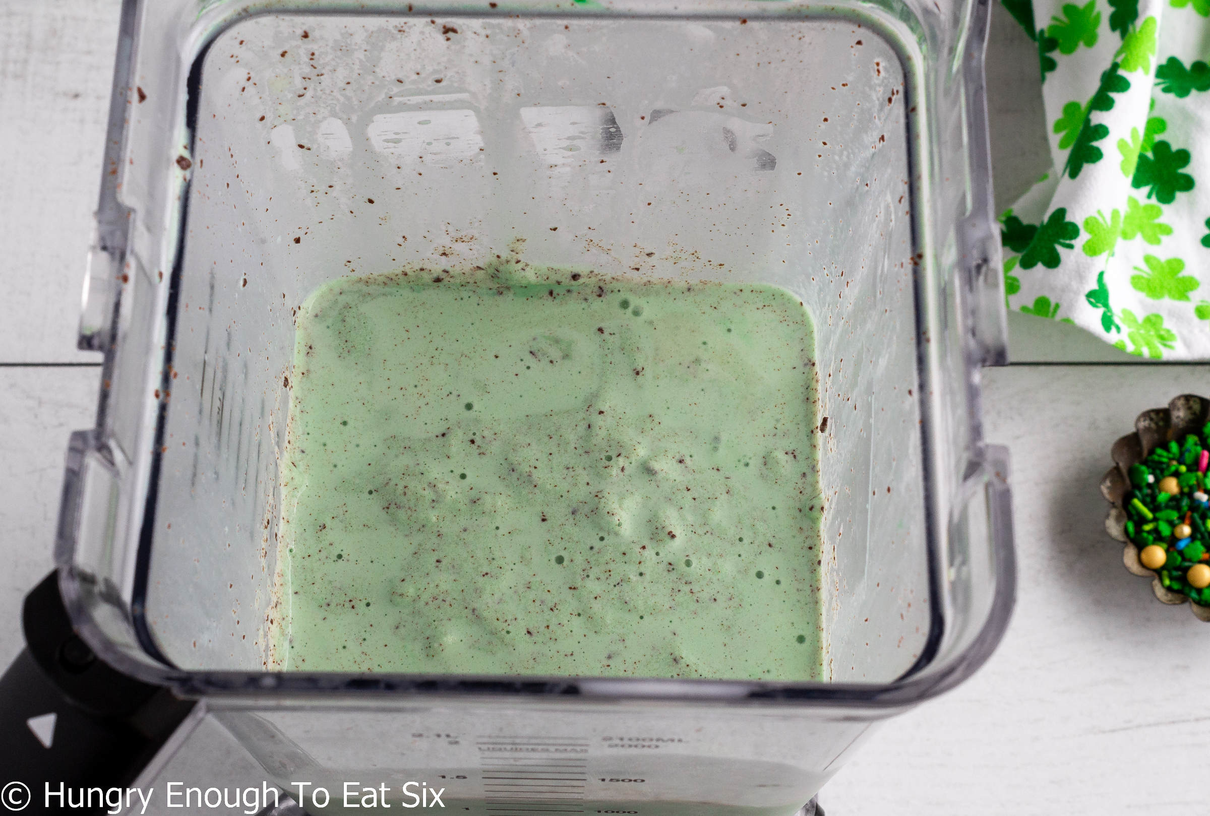 Green milkshake blended inside blender.