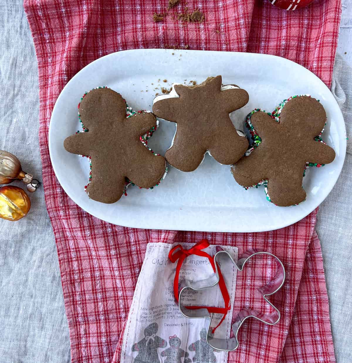 Three gingerbread men ice cream sandwiches, one with a missing head.