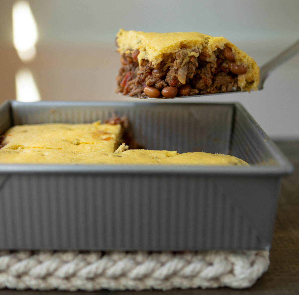 Cornbread topped casserole with beef and beans.
