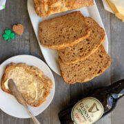 Slices of cheese bread next to bottle of Guinness beer.