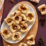 White platter holding pastry fig and apple brie bites.