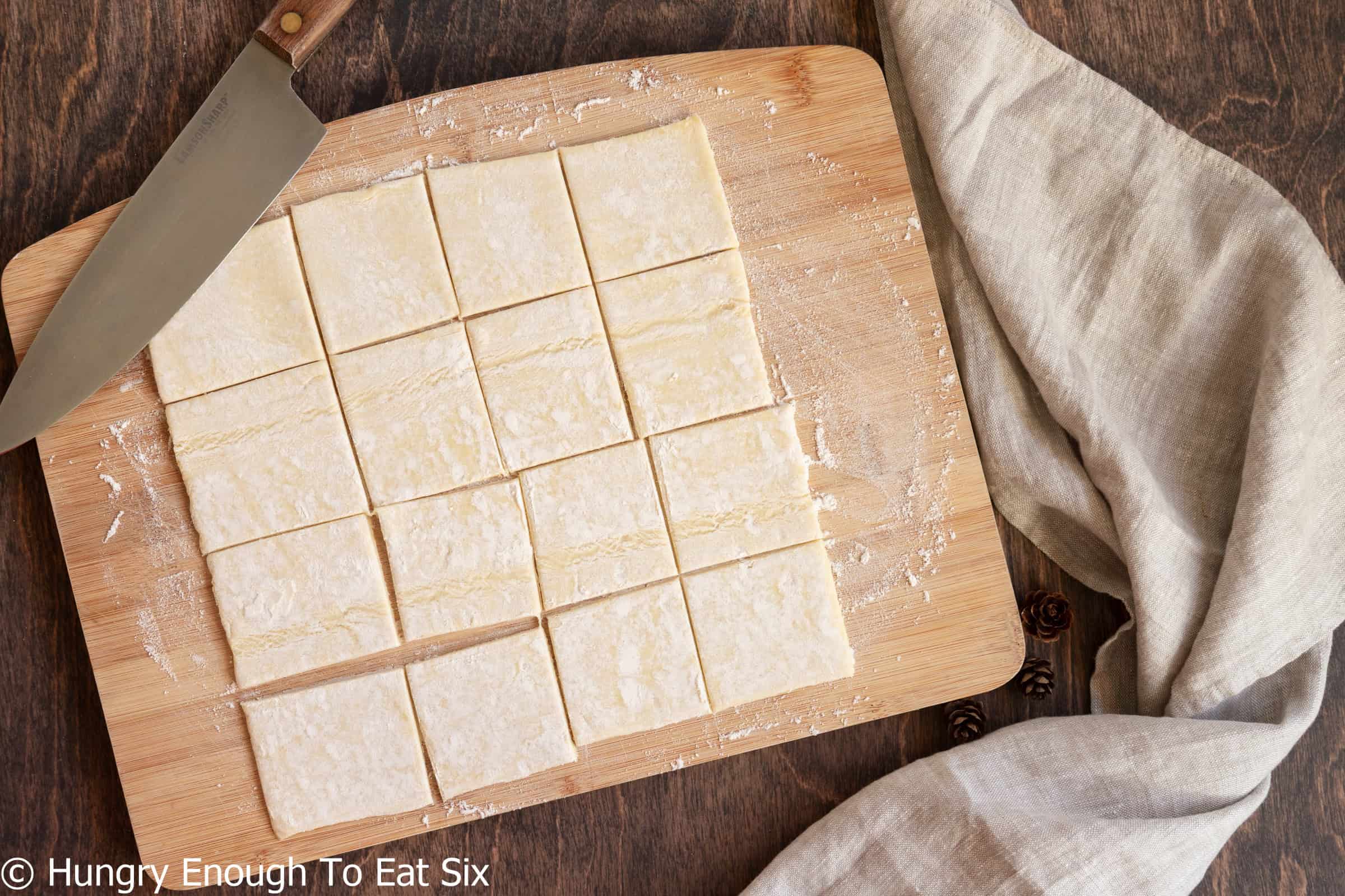 Squares of puff pastry cut to make fig and apple brie bites.