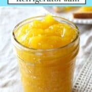 Jar of orange colored mango jam.