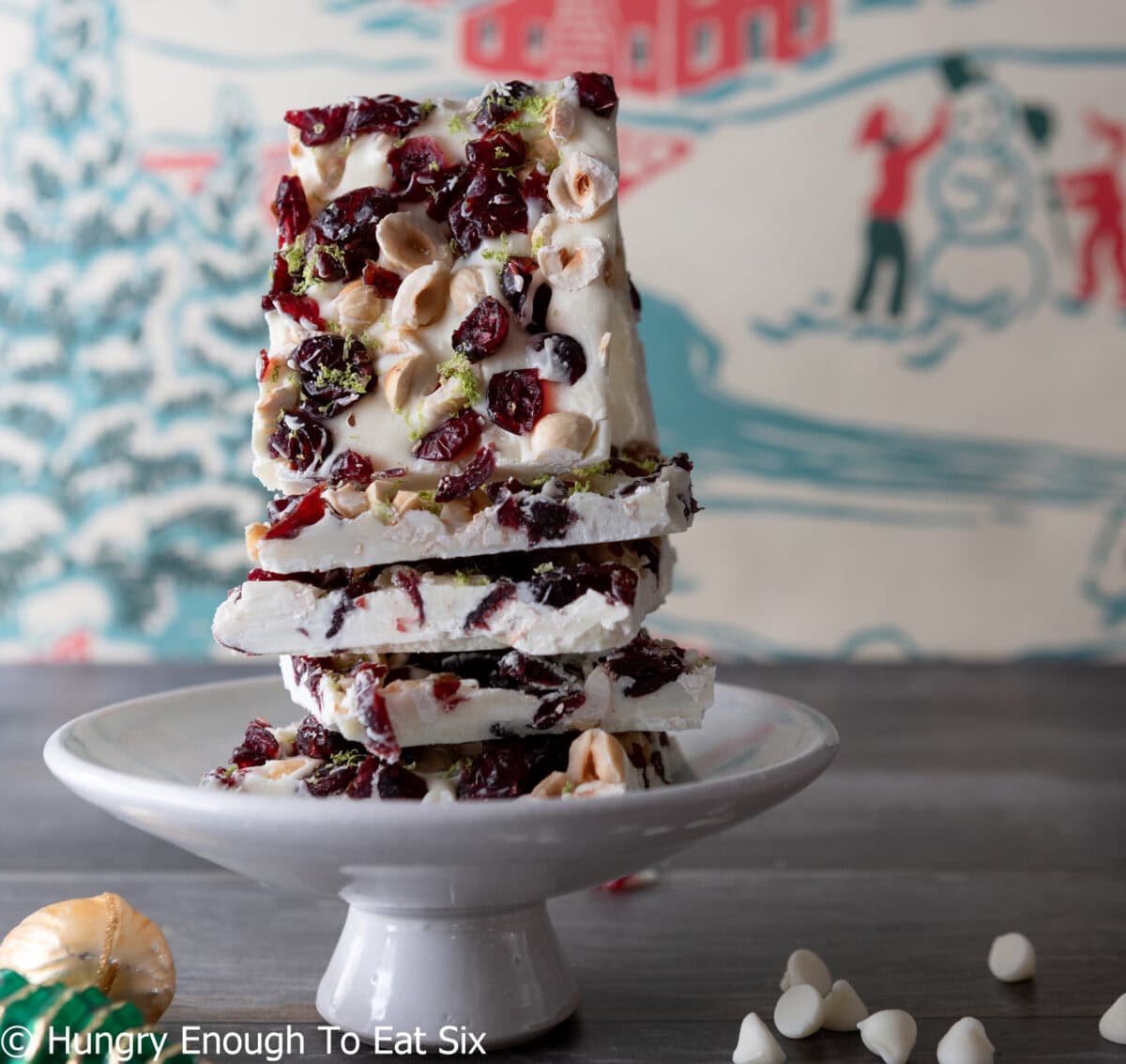 A stack of cranberry white chocolate bark pieces on a stand.