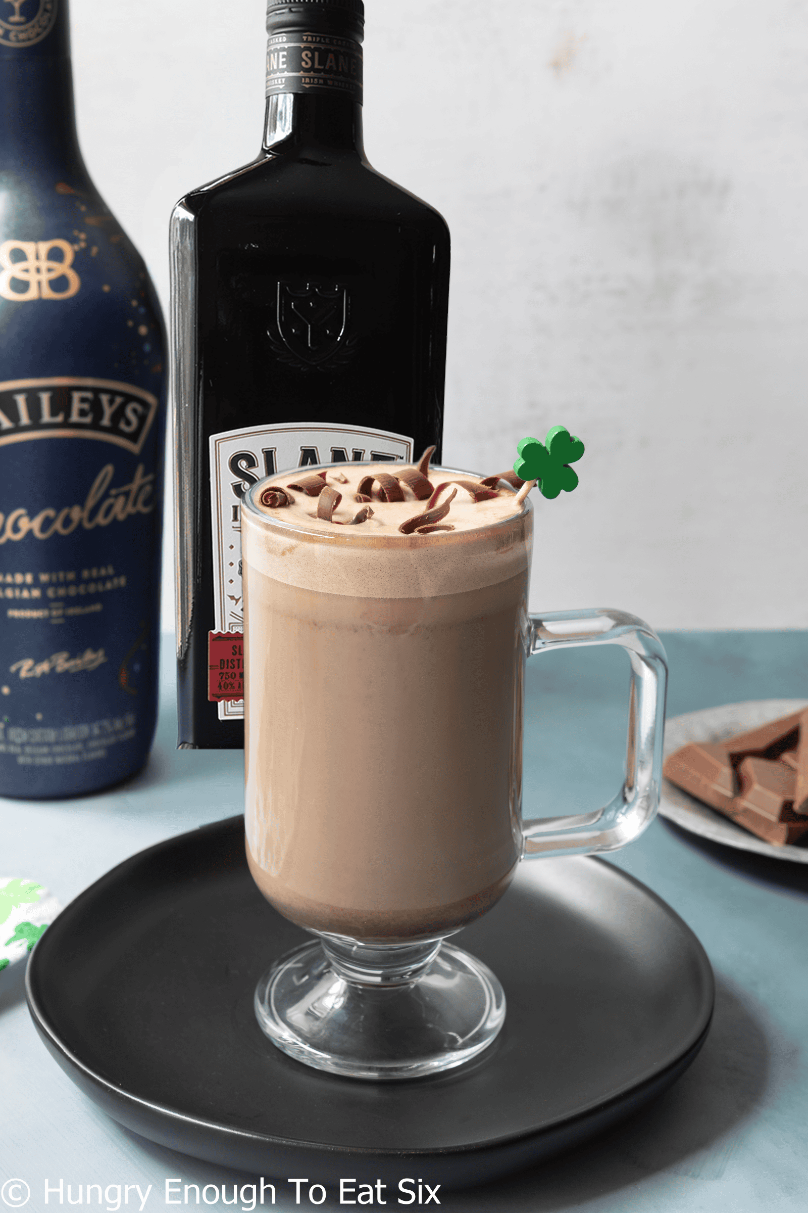 Baileys and Irish cream next to a mug of hot chocolate Irish coffee.