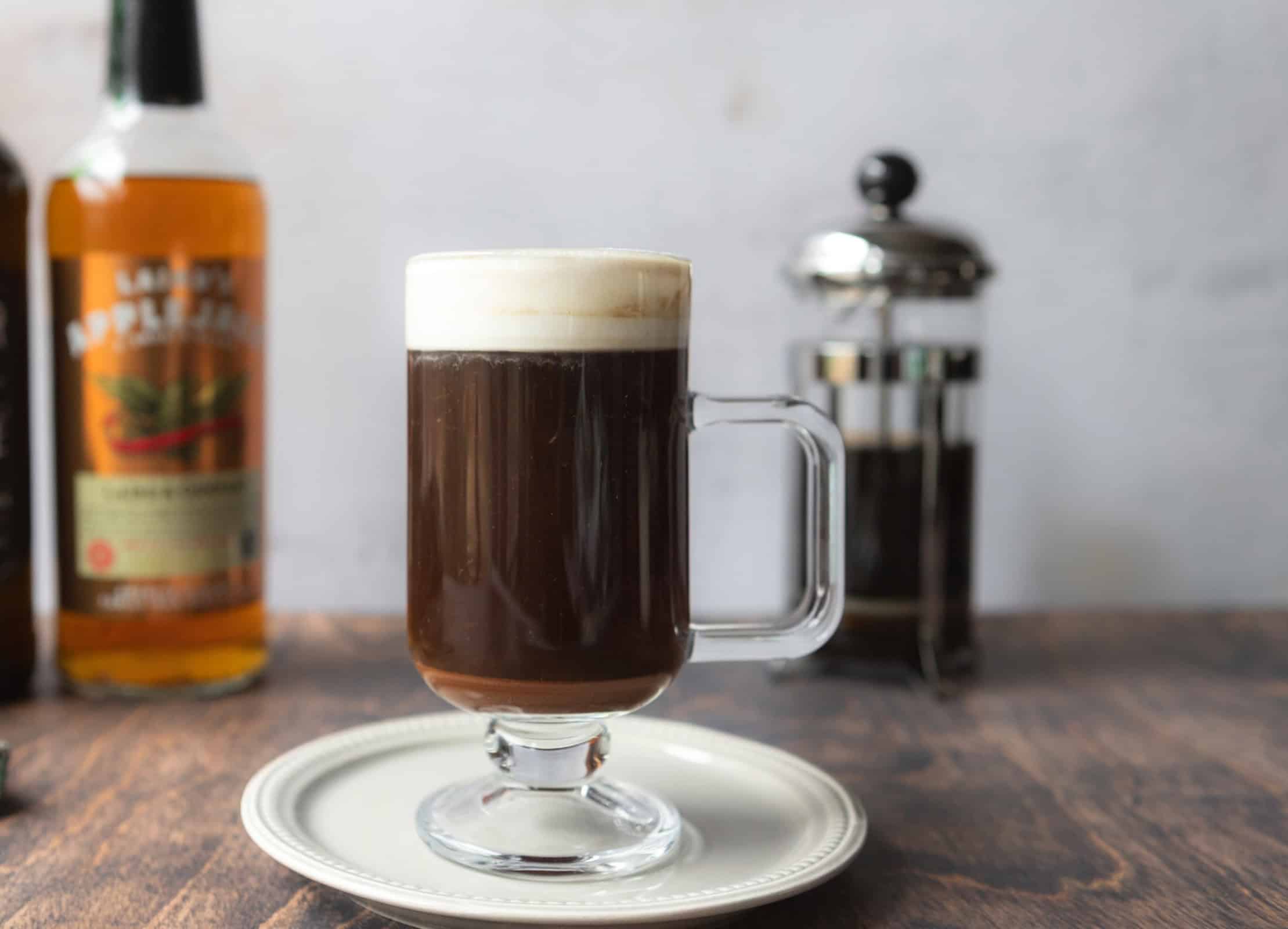 Foam topped Irish coffee with apple cider liqueur.