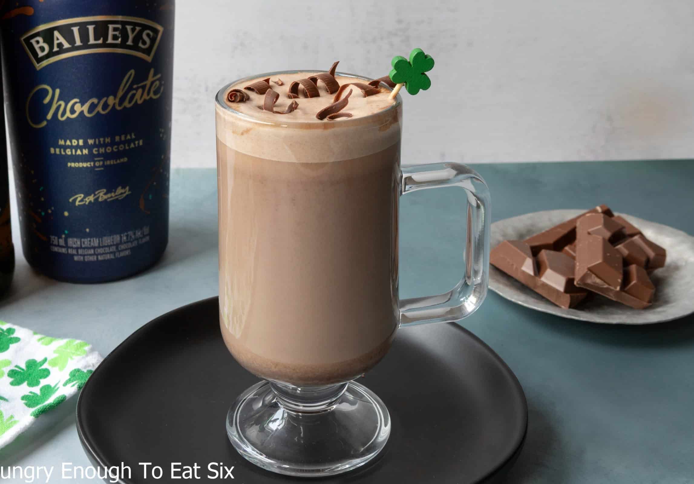 Chocolate Irish coffee in a glass mug with chocolate shavings.