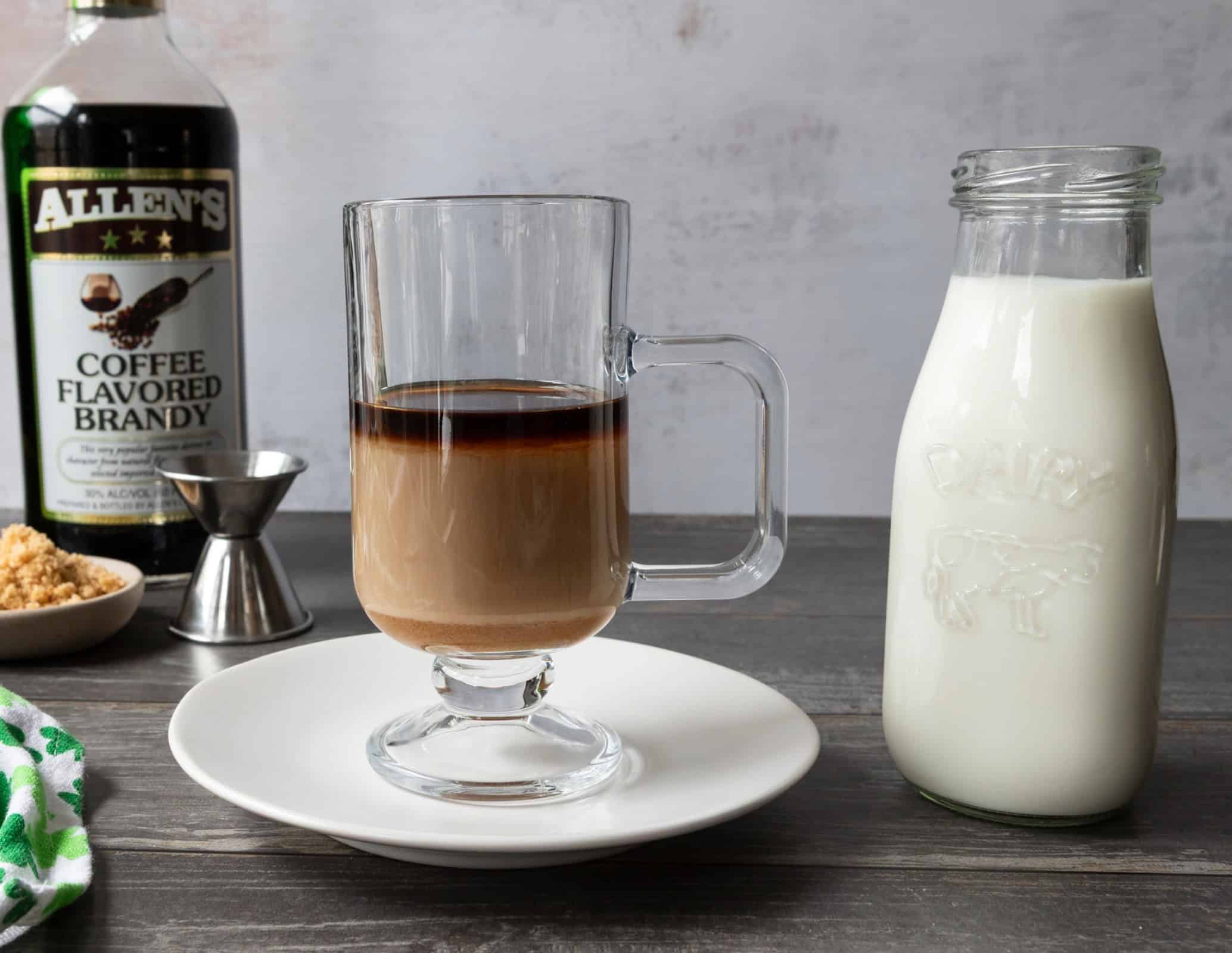 Glass mug with whiskey and liqueur, for a coffee brandy Irish coffee.
