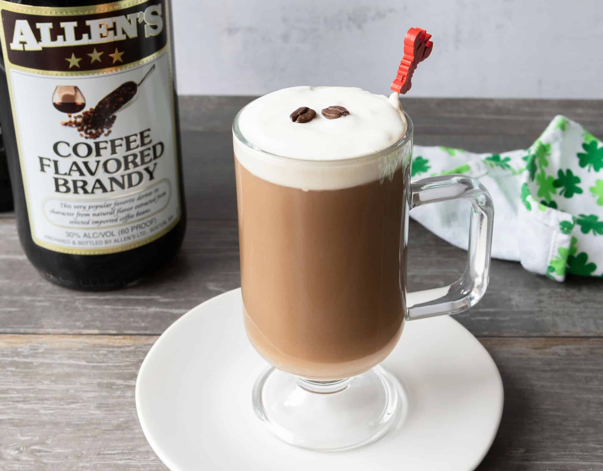 Cream-topped coffee brandy Irish coffee with a lobster pick.