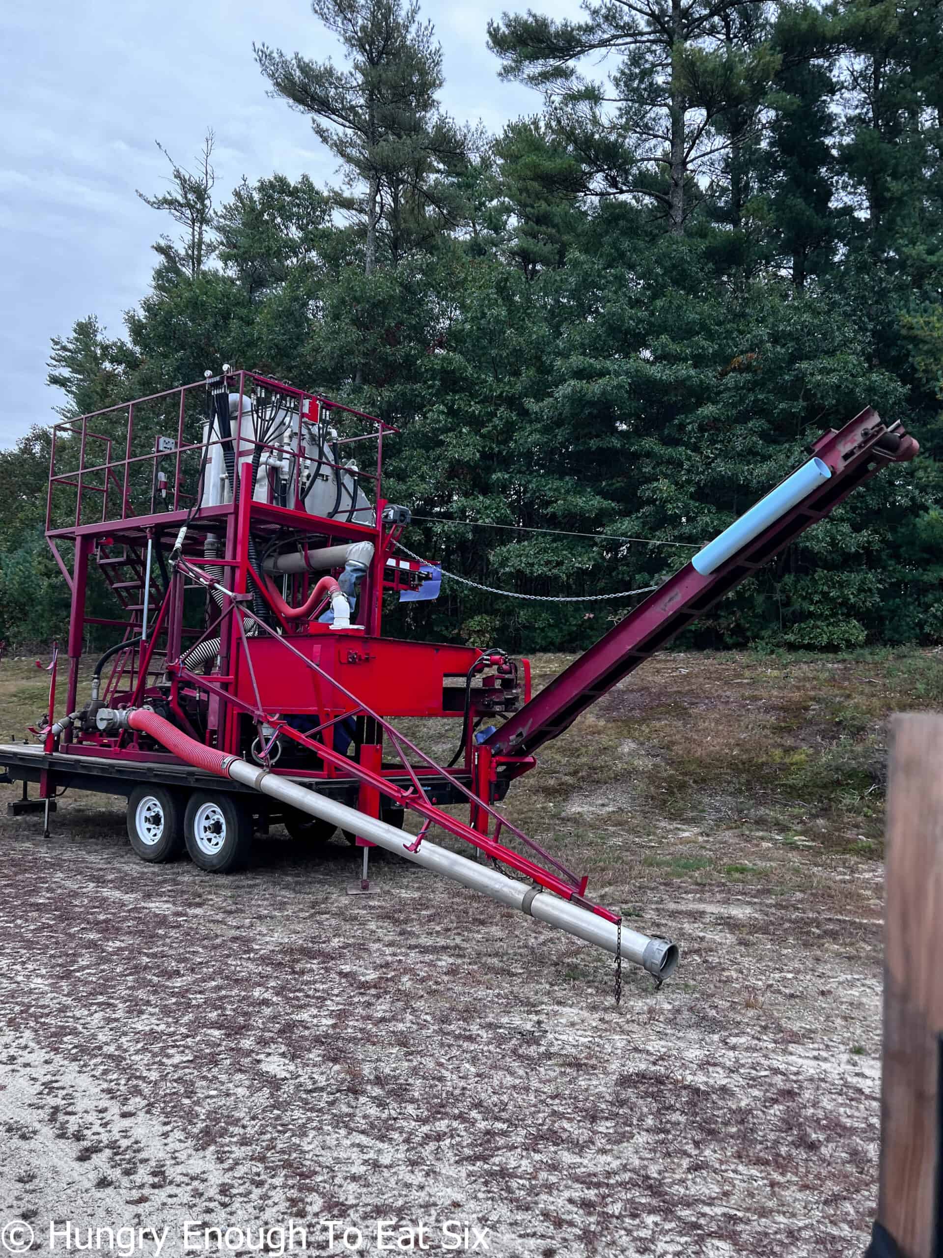 Large piece of red farm equipment.