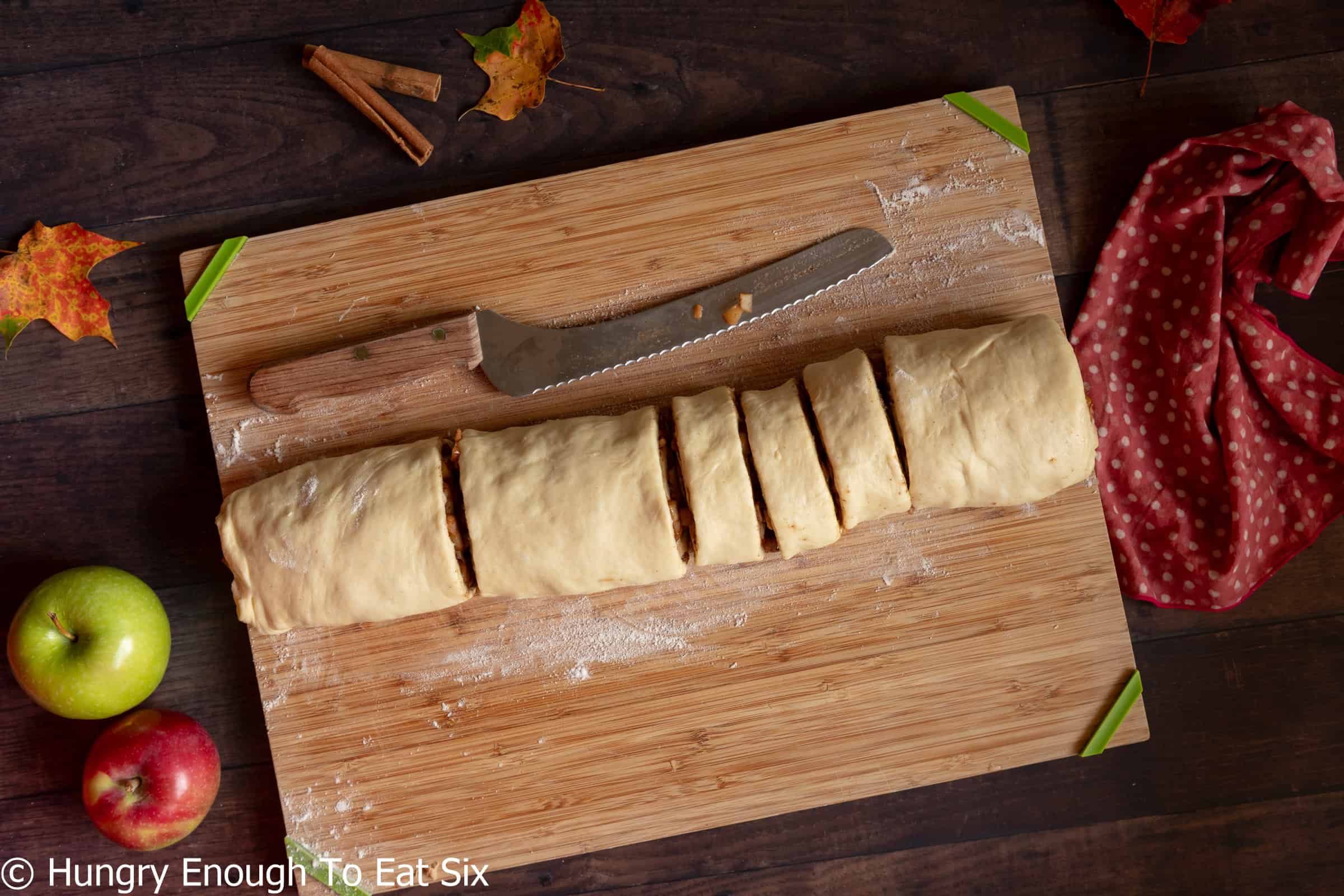 Rolled up cylinder of dough, with slices cut into it.