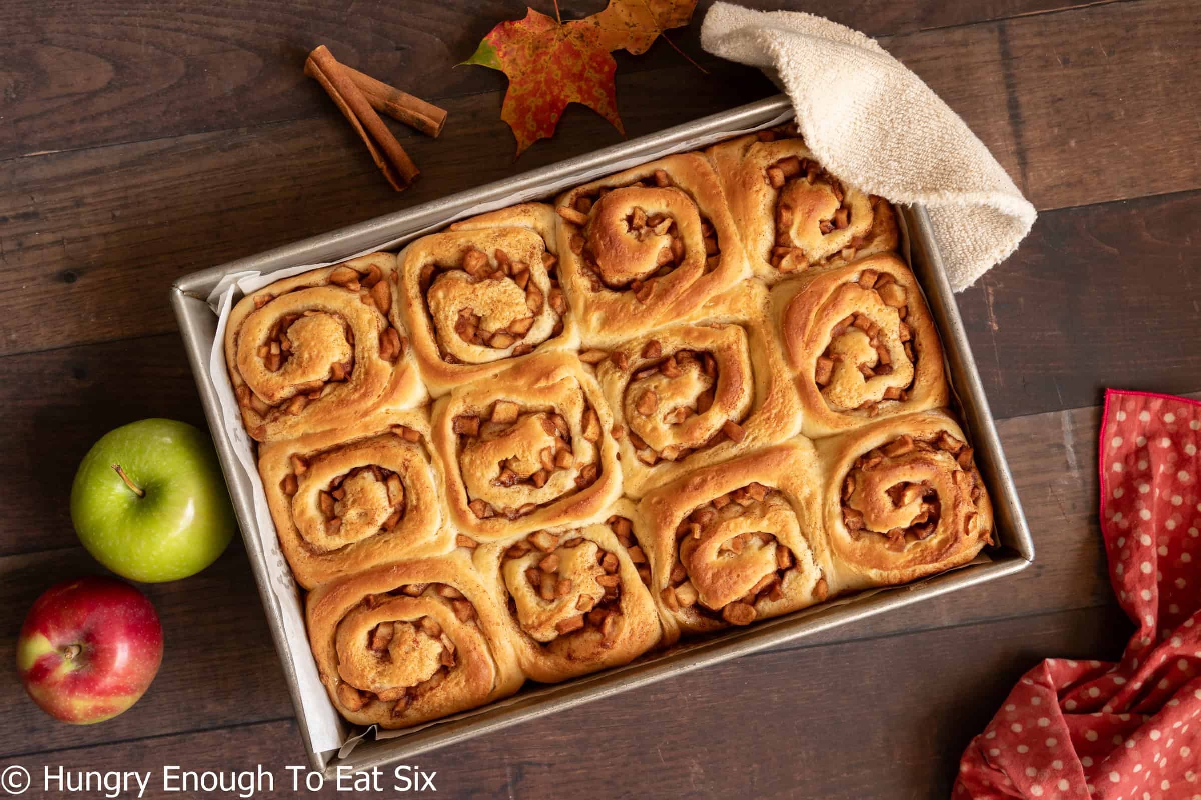 Twelve baked cinnamon rolls in a rectangular pan