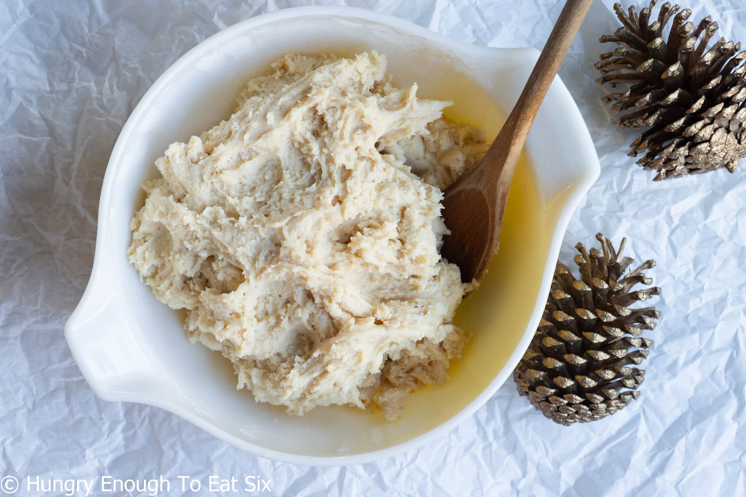 Vanilla Cozy-Ups sugar cookie dough in a bowl with a wooden spoon.
