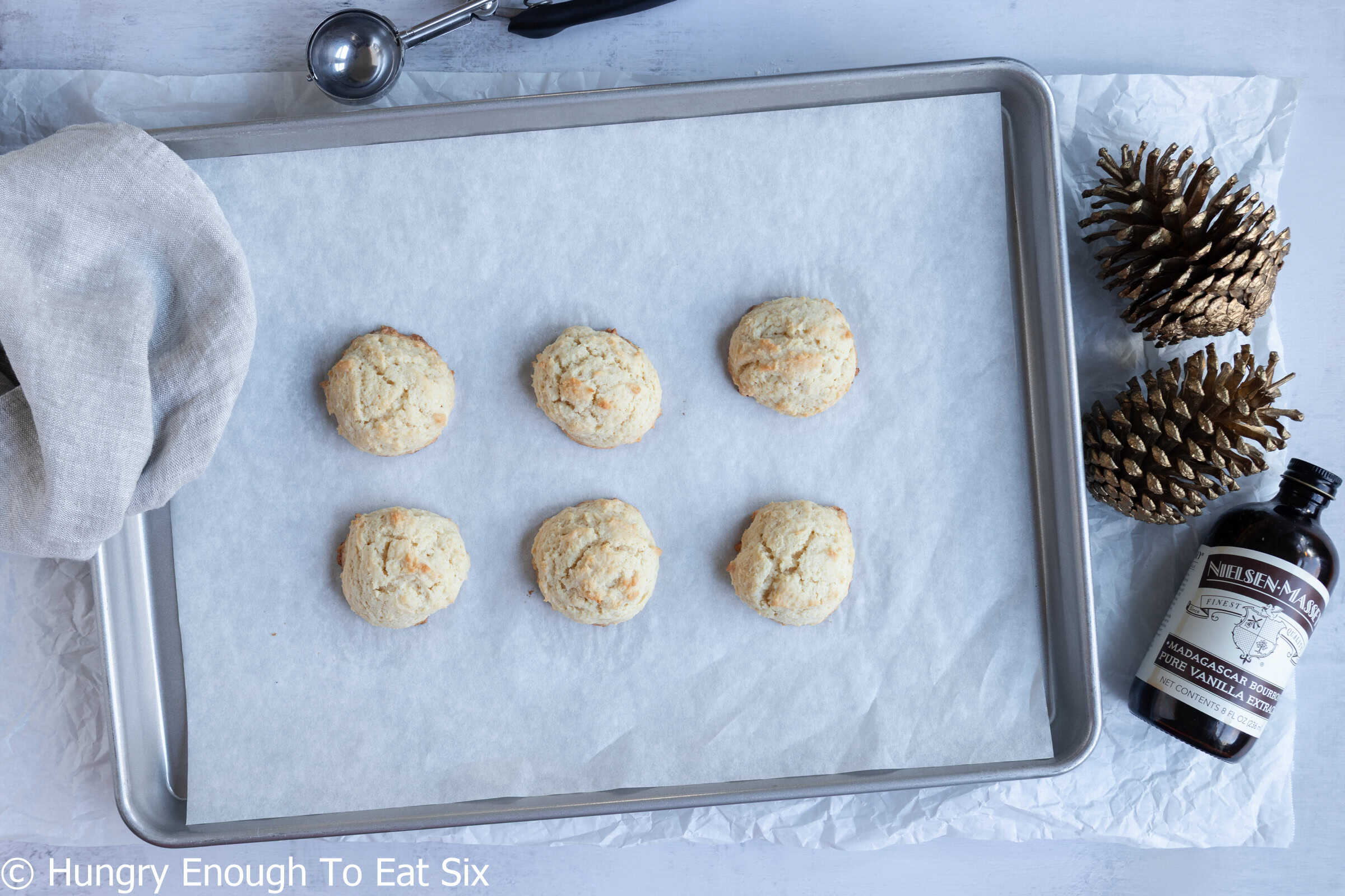 Baked Cozy-Ups soft sugar cookies on a lined baking sheet.
