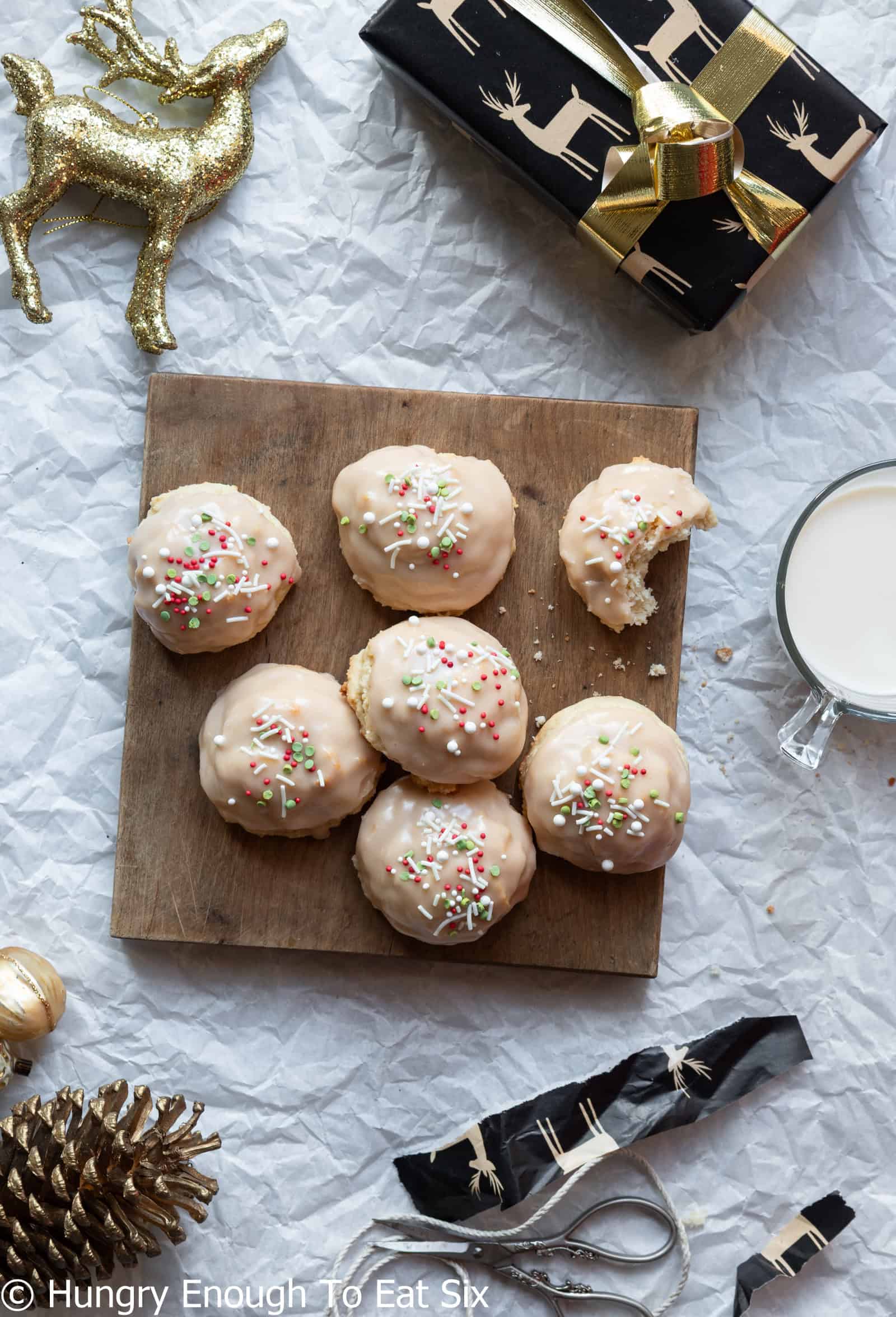Small cutting board with decorated Iced Vanilla Cozy-Ups cookies.