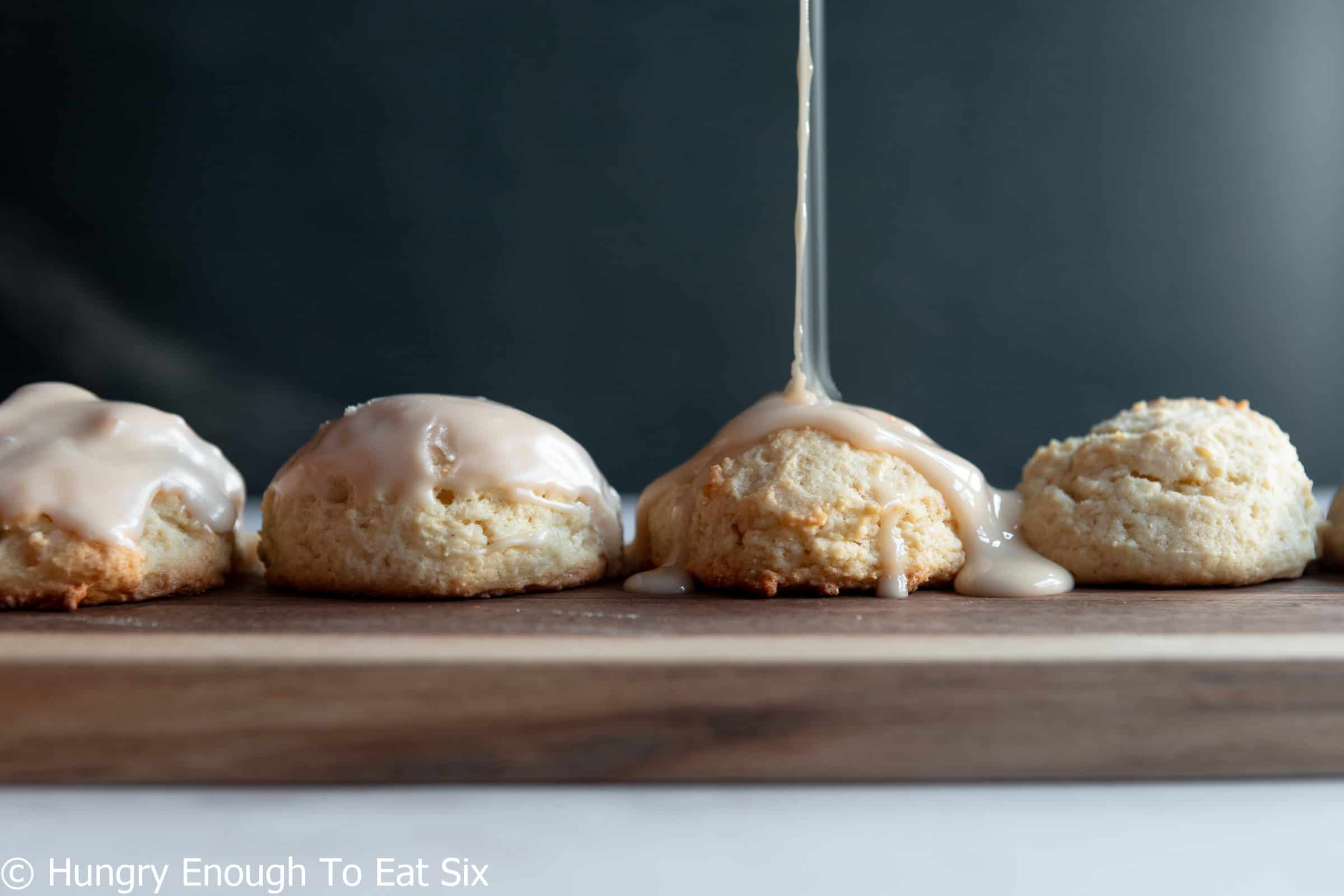 Row of Cozy-Ups Vanilla Sour cream sugar cookies with stream of icing.