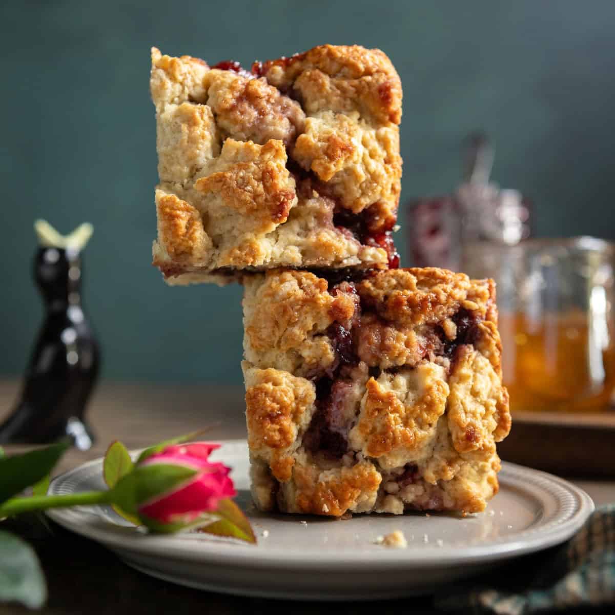 Two buttermilk scones with jam stacked on each other.