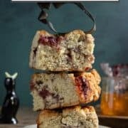Three square buttermilk scones stacked on one another with a strawberry cookie cutter.