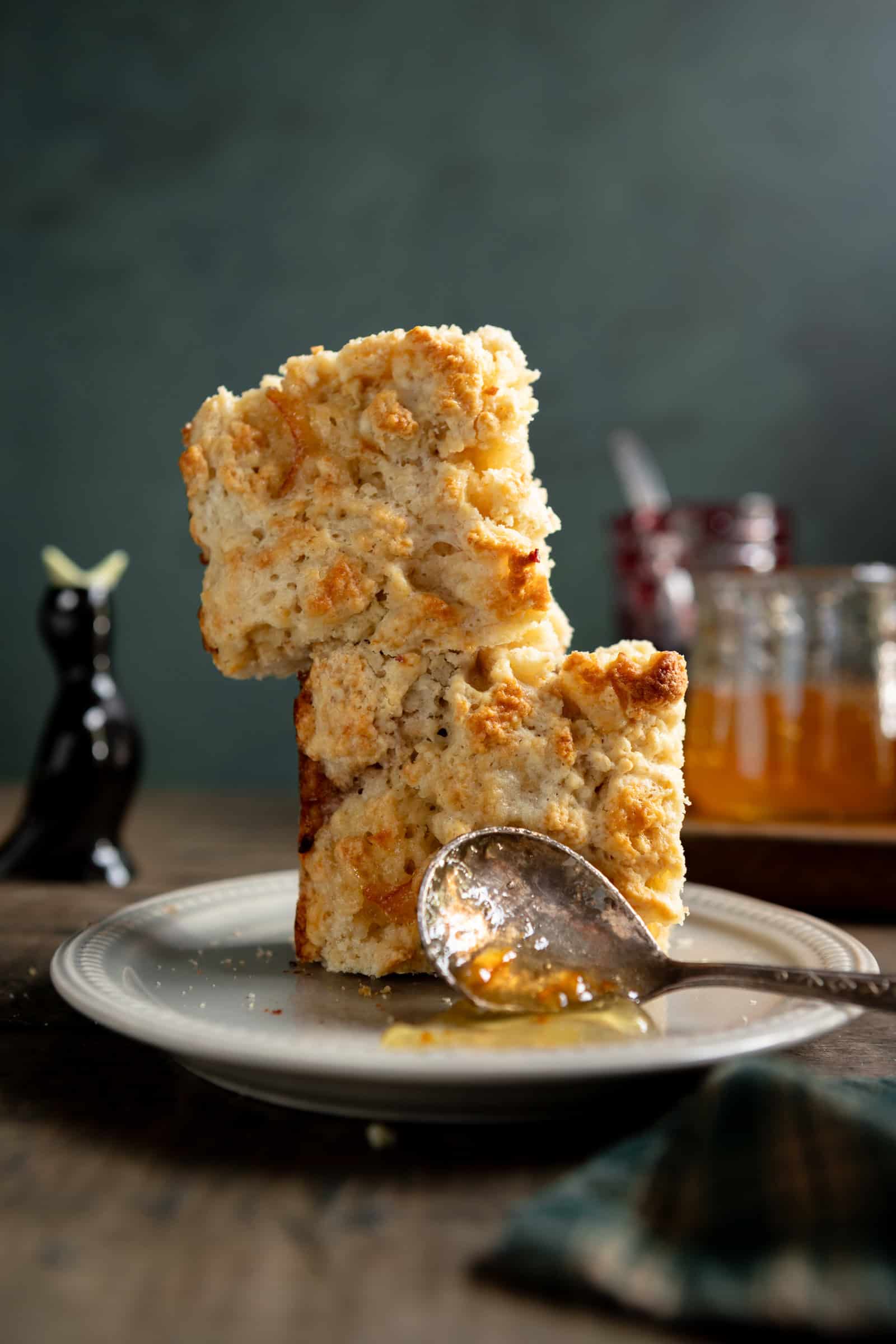 Light-colored baked scones with spoonful of orange marmalade.