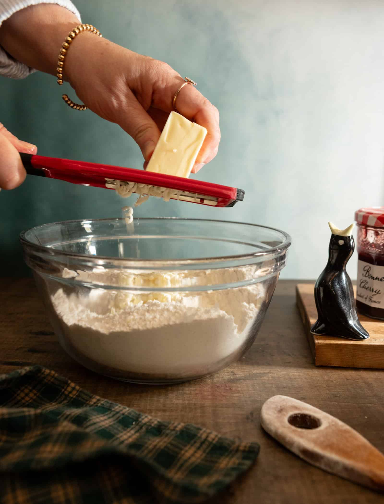 Hand grating cold butter into dry ingredients for buttermilk scones.