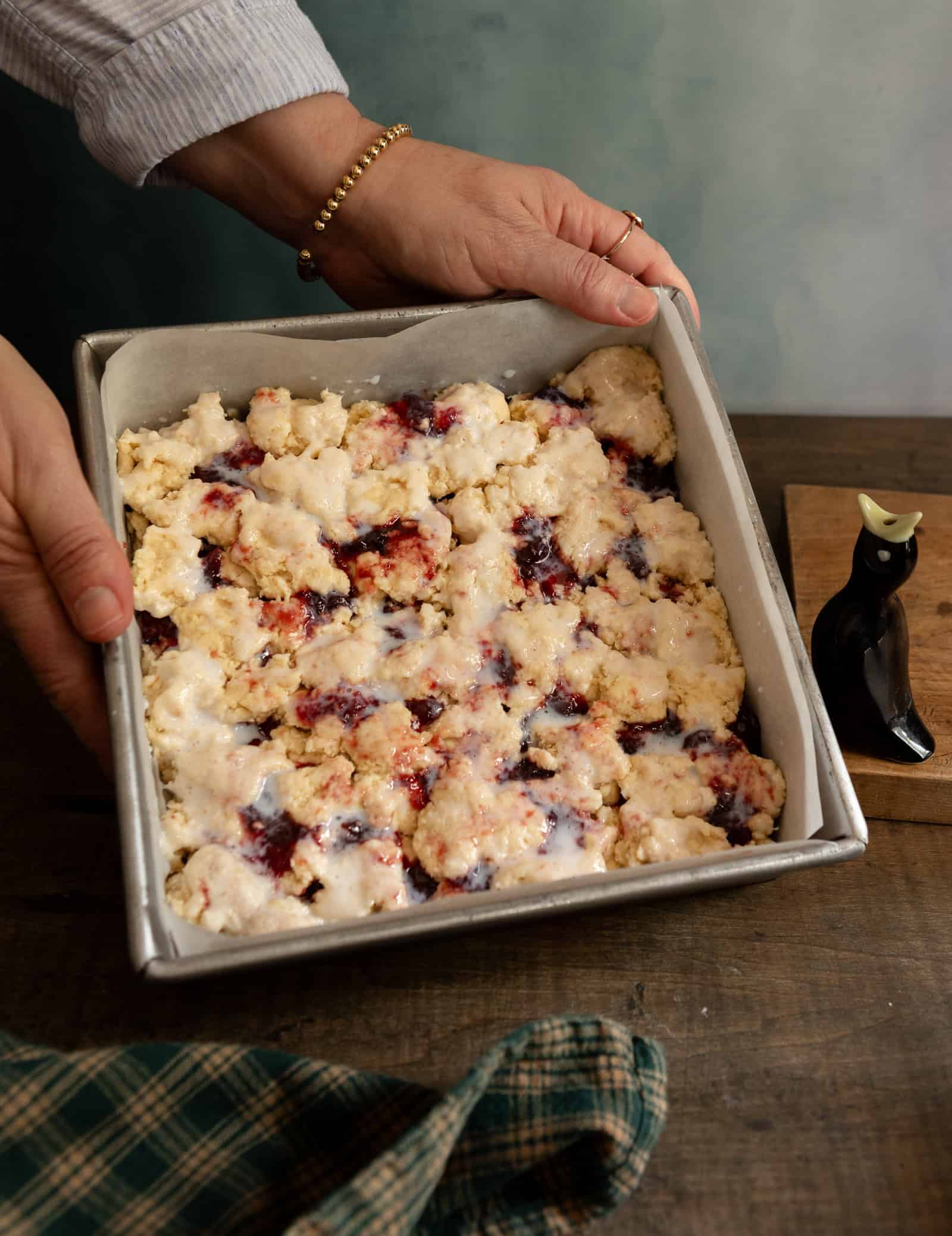 Baking pan of buttermilk scone dough pieces and jelly dollops.