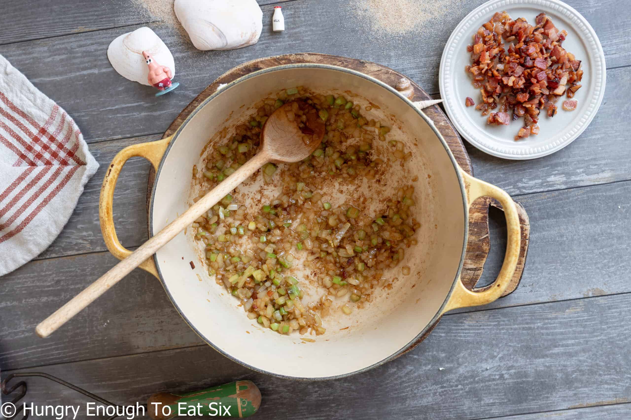 Sauteed aromatics for the no-clam chowder base with a wooden spoon.