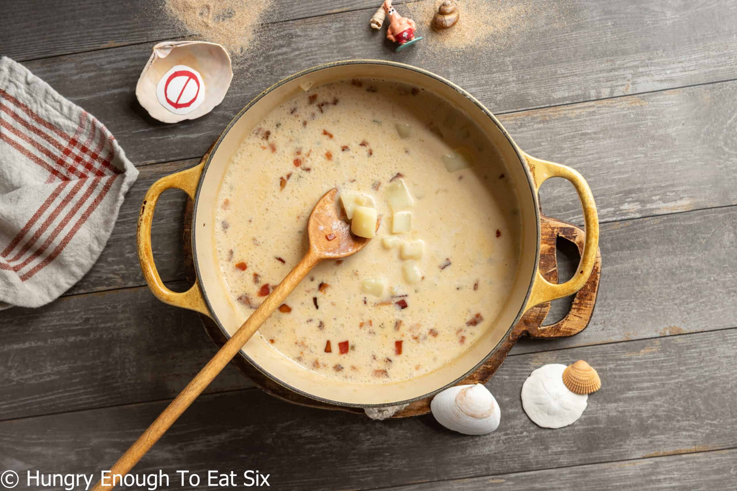 Yellow Dutch oven holding a creamy no-clam chowder.