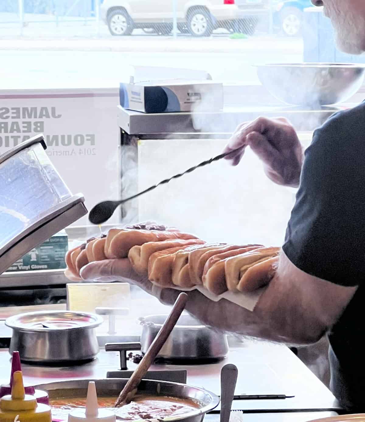 Eats on the road in Rhode Island featuring New York System wieners lined up on an arm.