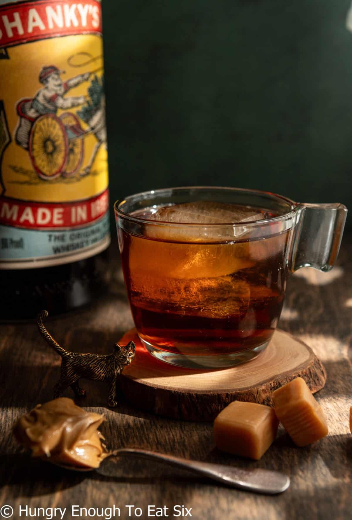 Friday night, a dark-colored cocktail in a glass with ice.