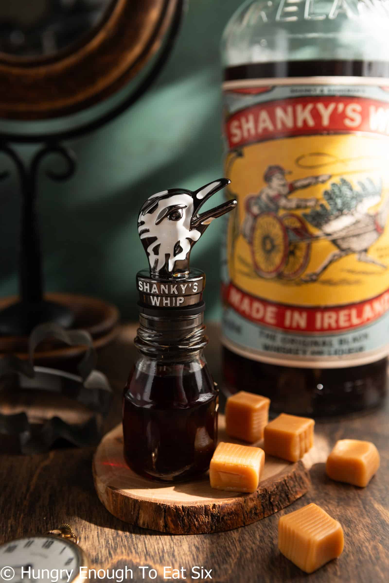 Small bottle of Shankys Whip with an ostrich head stopper, an ingredient in a Friday Night cocktail.