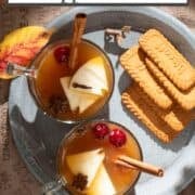 Cups of hot apple cider on a tray.